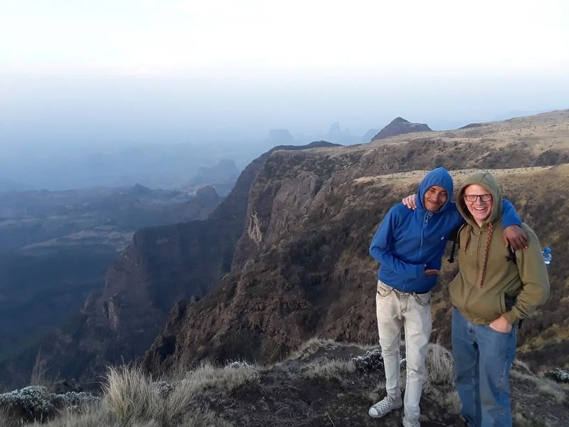 Two travellers on a cliff edge in Ethiopia's Simien Mountains
