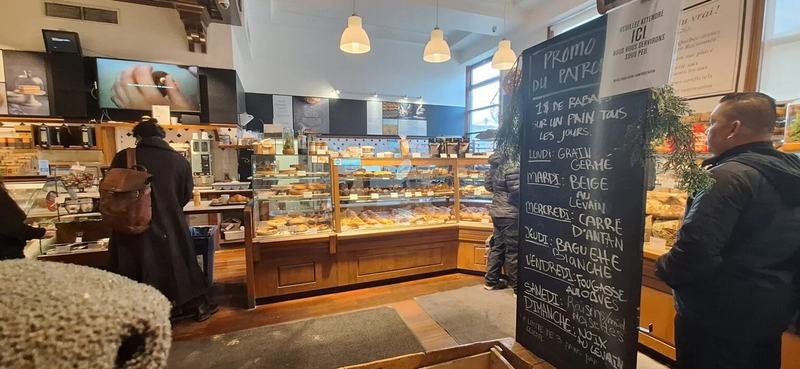 Inside a Montréal bakery, with the daily bread specials on a chalkboard