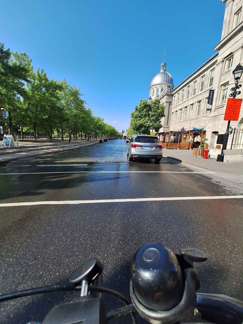 Rue de la Commune and the silver dome of Bonsecours Market, seen from a bike